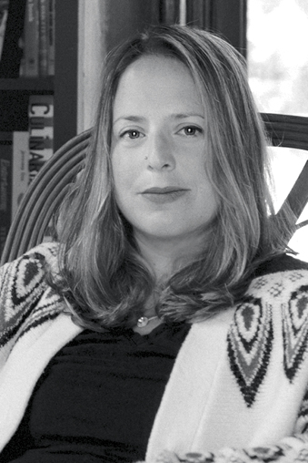 Portrait of Hannah Selinger seated indoors.